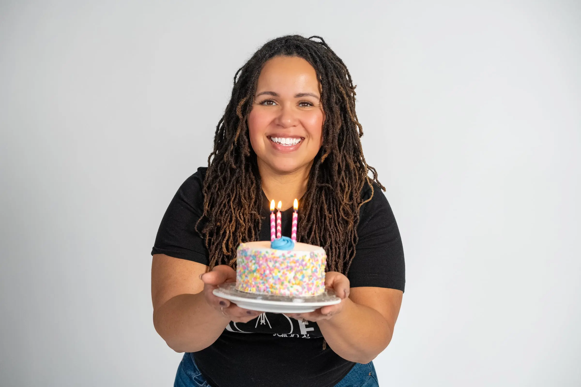 Loft stylist holding a sprinkle birthday cake