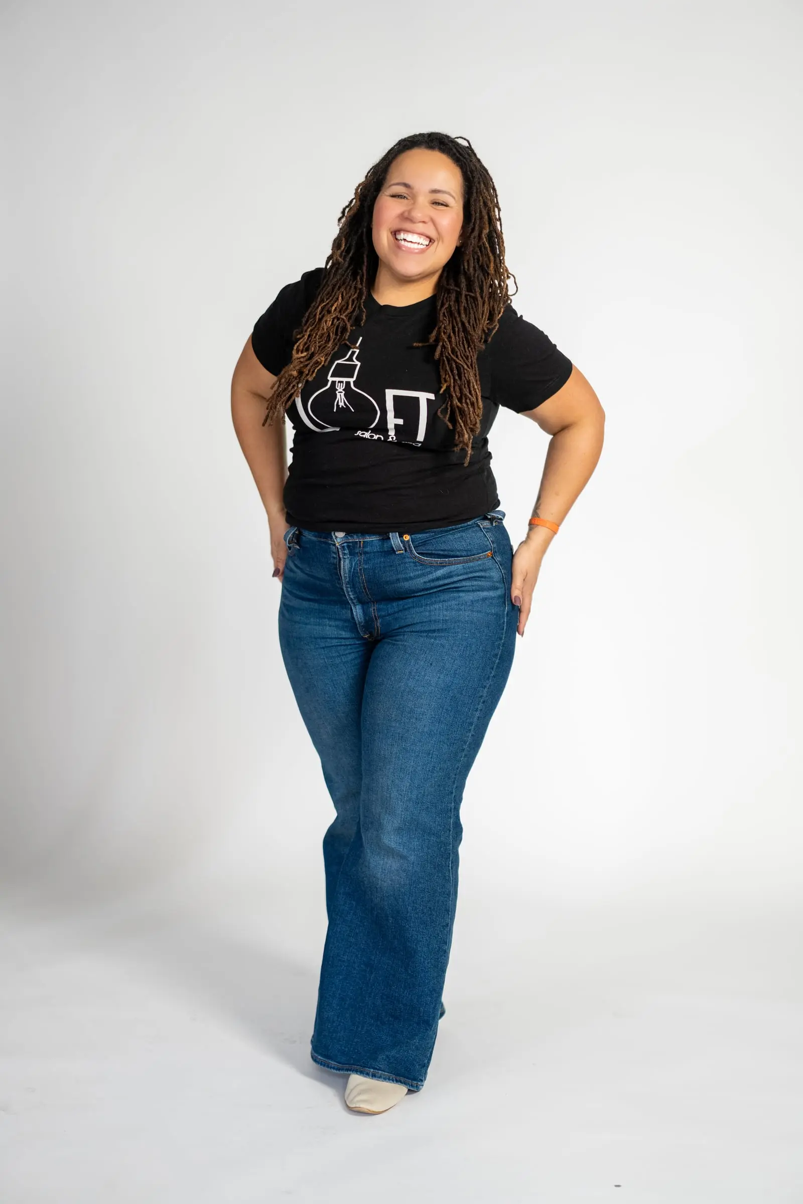 Loft stylist in a logo tee and wide-leg jeans