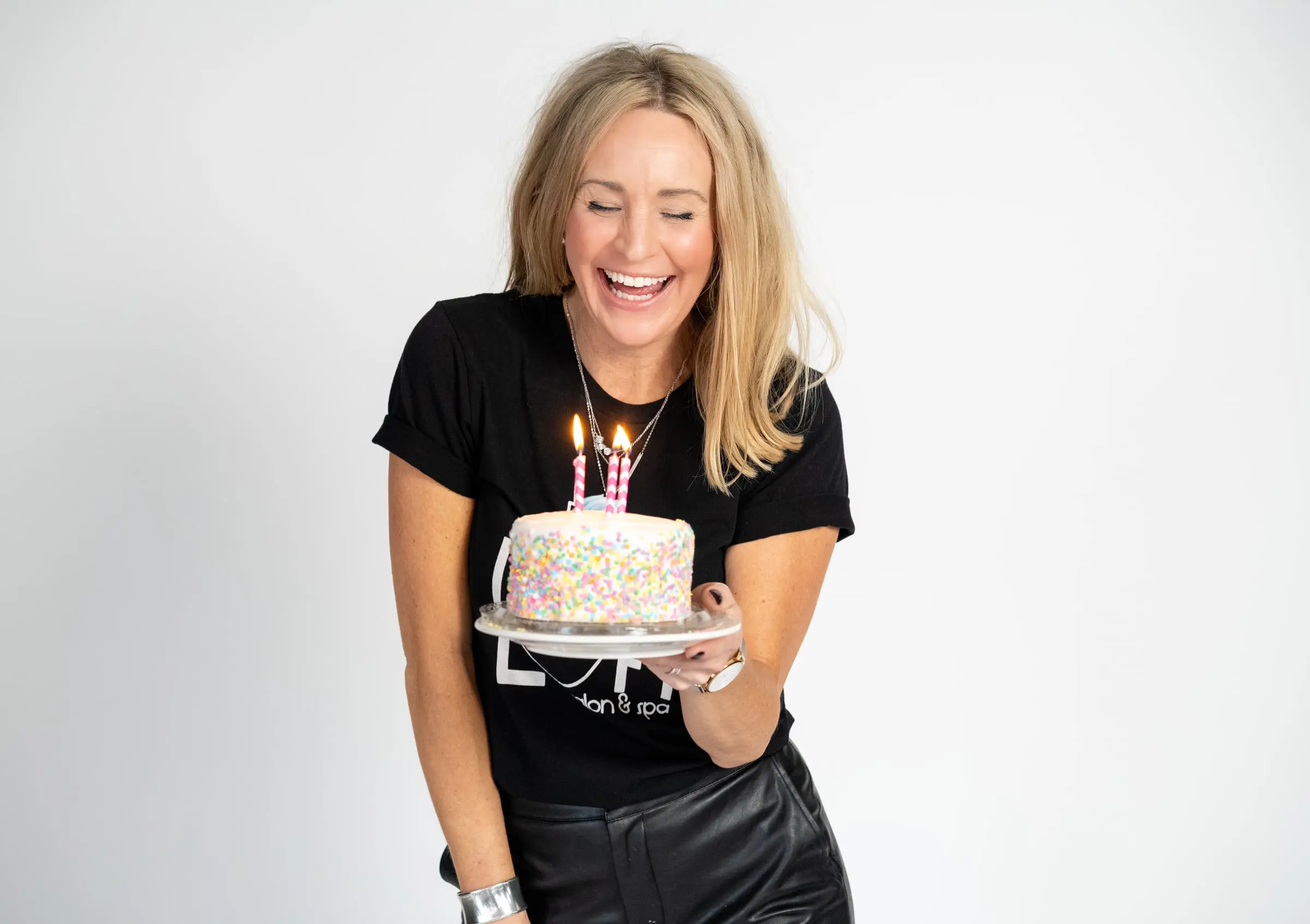 Loft stylist laughing with a sprinkle birthday cake