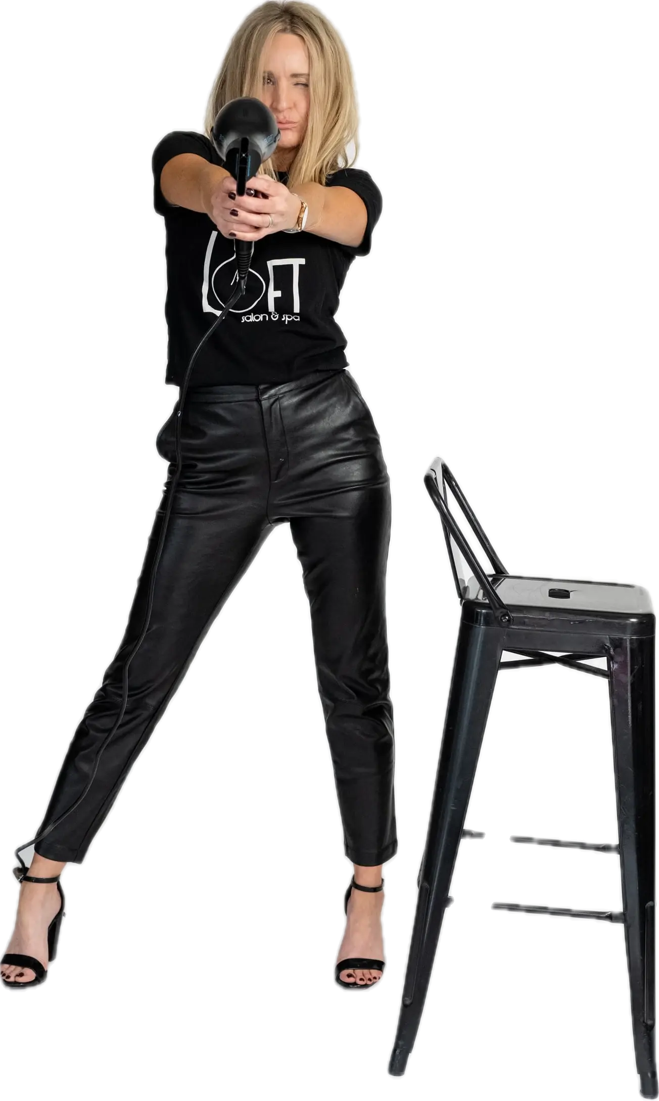 Loft stylist aiming a blow dryer at the camera