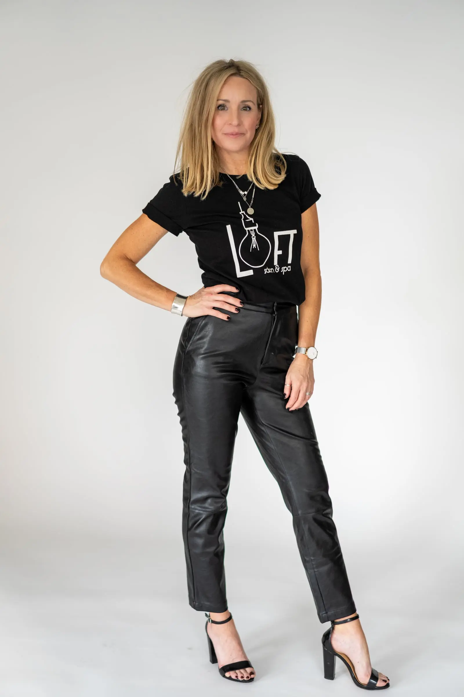 Loft stylist in a logo tee and leather pants